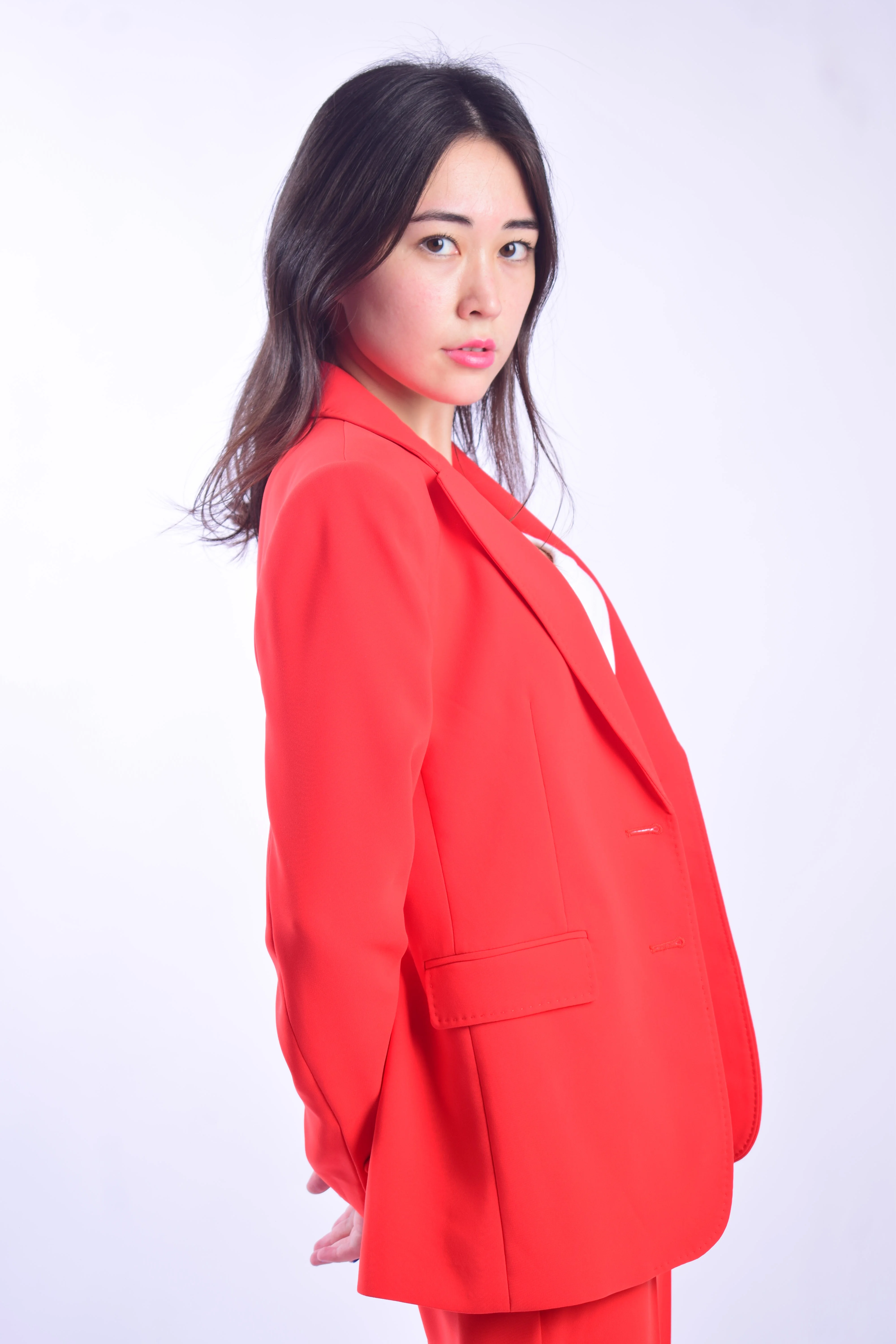 Bold red blazer headshot in Dubai, studio backdrop, personal branding photography